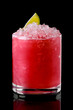 Glass of cold cranberry cocktail with crushed ice isolated on black