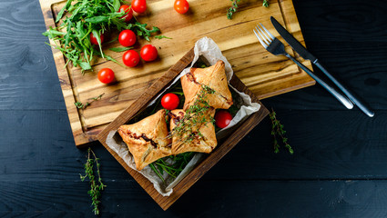 Sticker - samosa on a plate with sauce and tomatoes