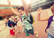 © Syda Productions - primary education and people concept - group of happy elementary school students with backpacks running and waving hands outdoors (out of focus, motion blurred image)