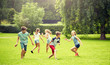 © Syda Productions - friendship, childhood, leisure and people concept - group of happy kids or friends playing catch-up game and running in summer park