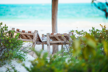 Wall Mural - White lounge chairs on a beautiful tropical beach at Maldives