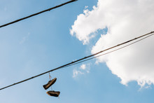 Old Shoes Hanging By The Laces In The Sky