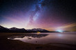 © Tandem Stock - The Milky Way and a starry sky are illuminated above snow-capped mountains and Lake Tahoe at Kiva Beach, South Lake Tahoe, California