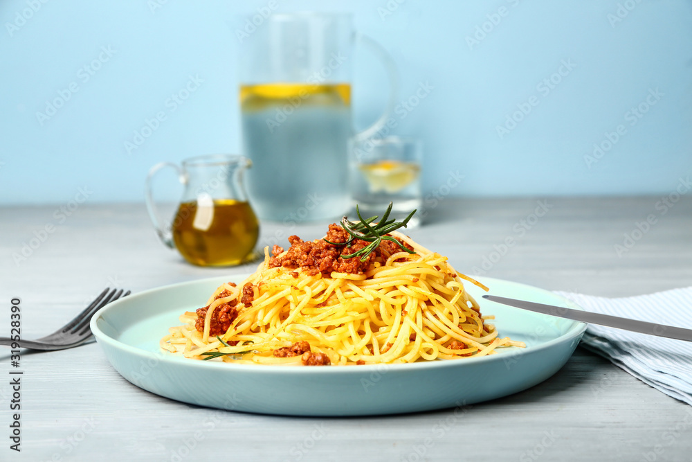 Plate with tasty pasta bolognese on wooden table