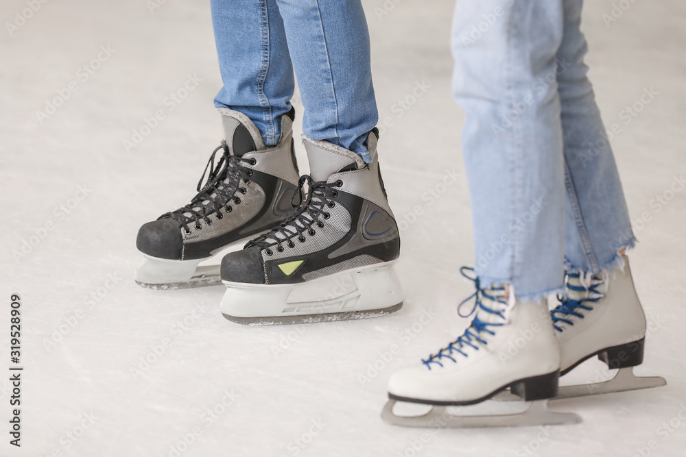 Young couple on skating rink