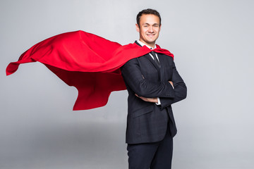 Young handsome businessman in suit and hero cout isolated on white background