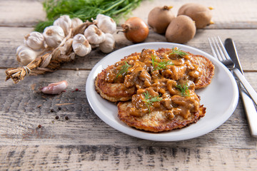 Wall Mural - Tasty homemade potato pancakes with meat and mushrooms