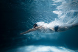Fototapeta Łazienka - professional swimmer underwater after the jump