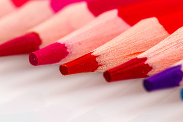 macro multicolored pencils on a white background