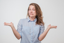 Unsuspecting Woman Shrugs Shoulders Of Helplessness Being Unsure