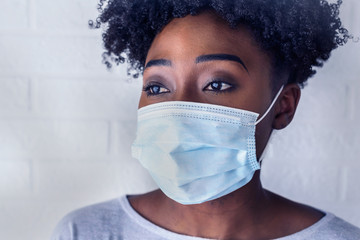 Young African Woman Wearing A Surgical Face Mask