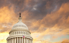 US Capitol Dome With American Flag And Dramatic Sky Behind