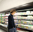 © lado2016 - Teenager shopping in supermarket, reading product information