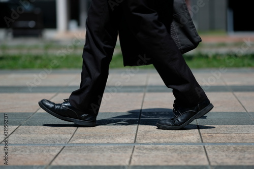 朝の駅前で革靴とスーツで歩く男性の足元 Stock Photo Adobe Stock