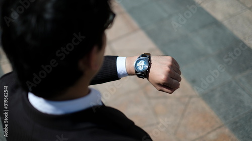 スーツ姿で時間を気にして腕時計を見る若い日本人男性 Stock Photo Adobe Stock スーツ姿で時間を気にして腕時計を見る若い日本人男性 Stock Photo Adobe Stock