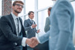 © ASDF - happy young businessman shaking hands with his business partner