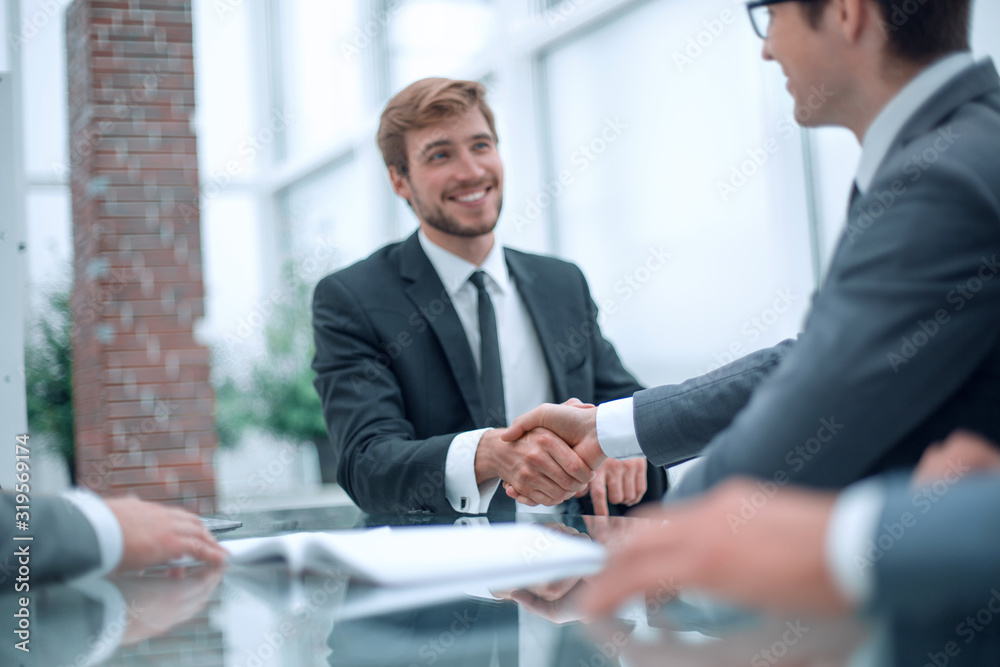 business partners greet each other at a business meeting. - obrazy, fototapety, plakaty 