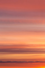 Wall Mural - Dramatic soft sunrise, sunset orange yellow red sky with clouds background texture