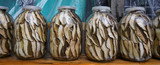 Fototapeta Panele - Photo of glass jars of preserved mushroom standing on the table