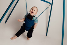 Jolly Baby Boy Bouncing In Jumper / Jumping Stand.