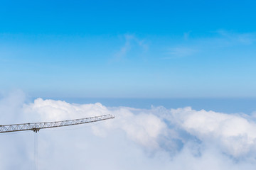 Wall Mural - a crane is a type of machine above beautiful white cloud summer blue sky and sun light.
