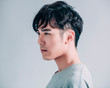 © Tom Wang - side view of young smiling handsome man isolated on gray background