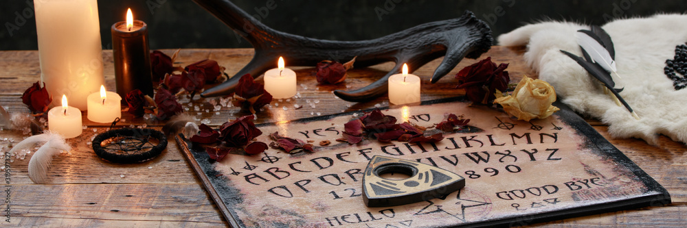 Mystic ritual with Ouija and candles. Devil's board concept, black magic or fortune telling rite with occult and esoteric symbols. - obrazy, fototapety, plakaty 