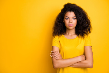 Close-up portrait of her she nice attractive lovely pretty calm content serious wavy-haired girl folded arms isolated over bright vivid shine vibrant yellow color background