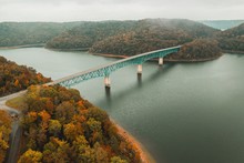 HIGH ANGLE VIEW OF BRIDGE OVER RIVER DURING AUTUMN