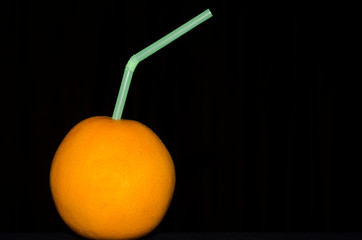 Orange Fruit with Plastic Straw on Black Background,