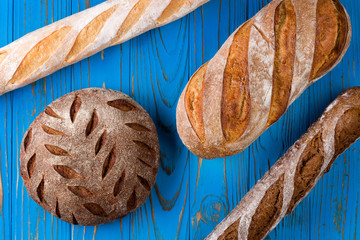 Top view photo of fresh baked bread on painted blue wooden table