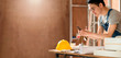 © whyframeshot - smart attractive handy glasses asian male craftman or interior designer focus wood working at site constrution home interior design renovation and improvement concept