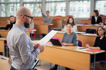 Wall Mural - Lecturer and multinational group of students in an auditorium