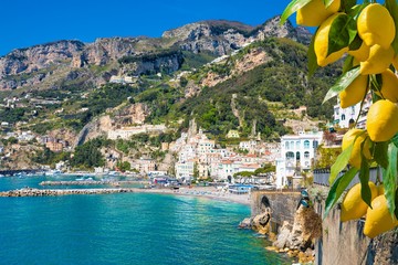 Wall Mural - Beautiful Amalfi on hills leading down to coast, comfortable beaches and azure sea in Campania, Italy. Amalfi is most popular travel destination in Europe.