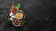 Hazelnuts in a bowl on a black stone background. Nut. free space for your text. Top view.