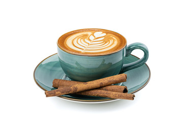 Side view of hot latte coffee with latte art and cinnamon sticks in a vintage ceramic green cup and saucer isolated on white background with clipping path inside. Image stacking techniques.