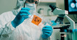 © JHDT Productions - medium shot lab tech with sample of Wuhan Coronavirus virus