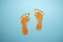 Drawing On A Blue Background. Orange Human Footprints