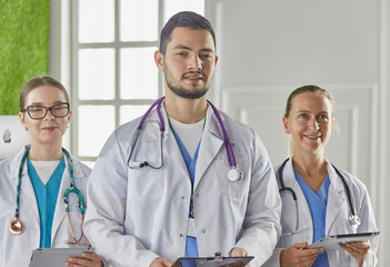 Portrait of group of smiling hospital colleagues standing together