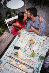 Wall Mural - cheerful young couple  with cocktails  having fun in nightclub celebrating. Fun, love, valentine’s day  concept.