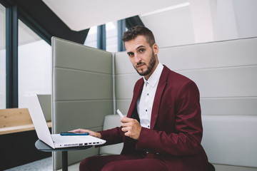 Successful male using laptop creating startup in office