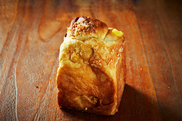 Poster - A loaf of cheese bread on wooden background 