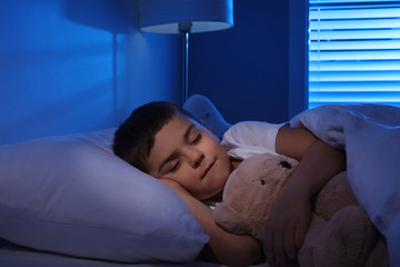 Wall Mural - Little boy sleeping with teddy bear at home. Bedtime