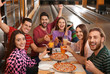 © New Africa - Group of friends with drinks and pizza in bowling club