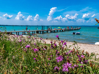 Lago di Garda in northern Italy, family tourism boats, crystal clear water, summer holidays vacations