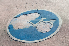 Bicycle Lane Sign On The Asphalt, Deteriorated By Time And Use.