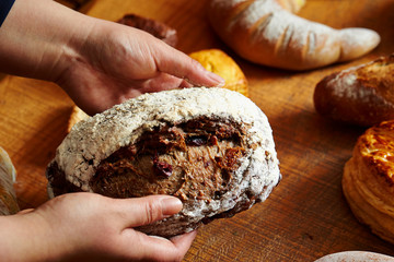 Wall Mural - Raisin bread in hand at bakery 