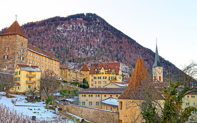 Sticker - St Martin Church and vineyard of Chur in the morning. Chur is the capital of canton Graubunden in Switzerland. It lies in the Alpine Grisonian Rhine valley. The city is the oldest town of Switzerland