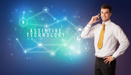 Businessman in front of cloud service icons with ASSISTIVE TECHNOLOGY inscription, modern technology concept