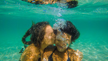 Couple Enjoying A Swim Underwater
